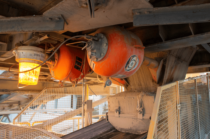 Air cannons installed on a belt conveyor transfer point.