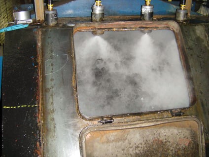 Looking down into a tranfer chute from the top head pulley you can see a dust suppression system spraying the coal.