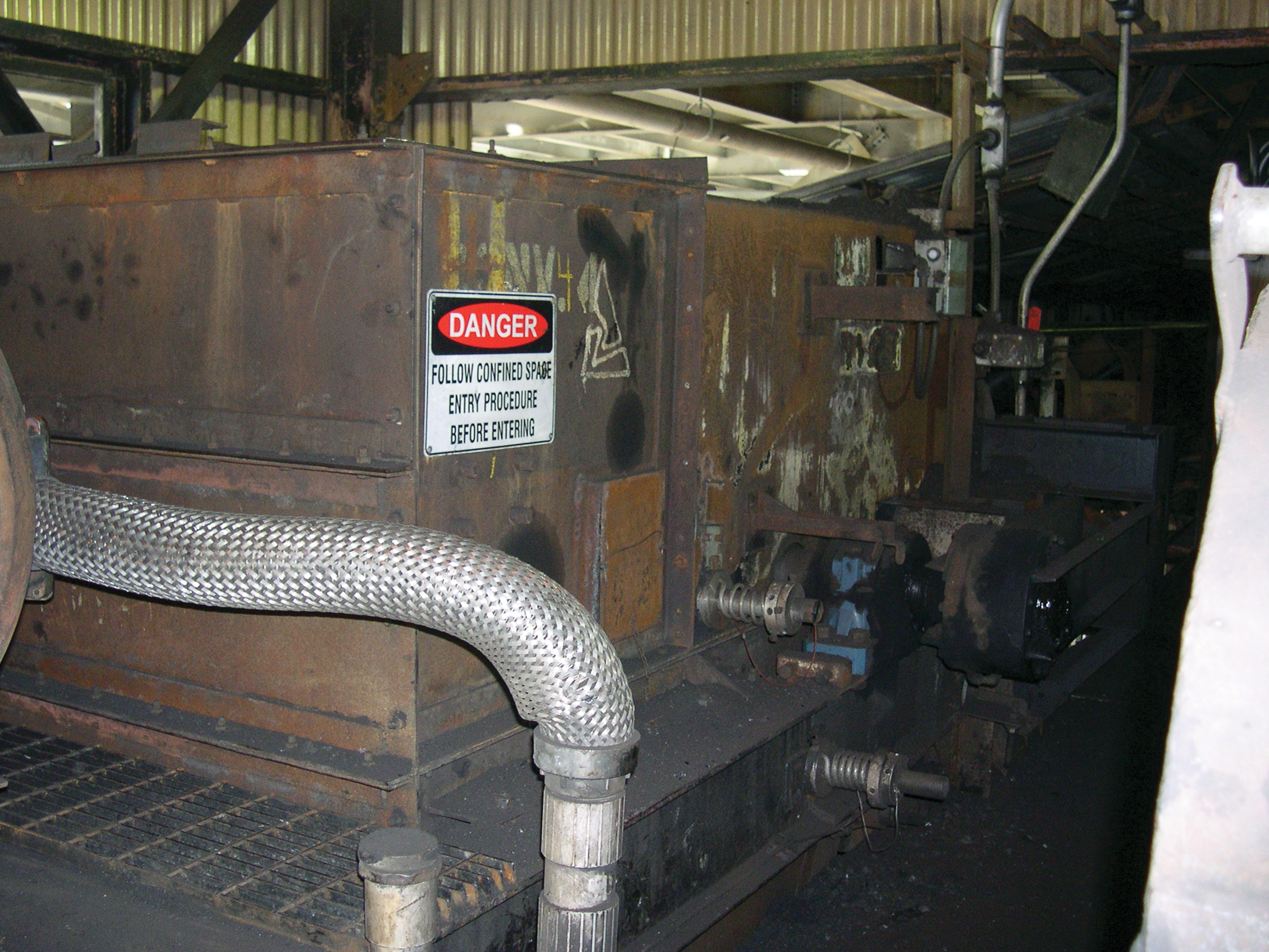 Safety signage on a belt conveyor transfer chute.