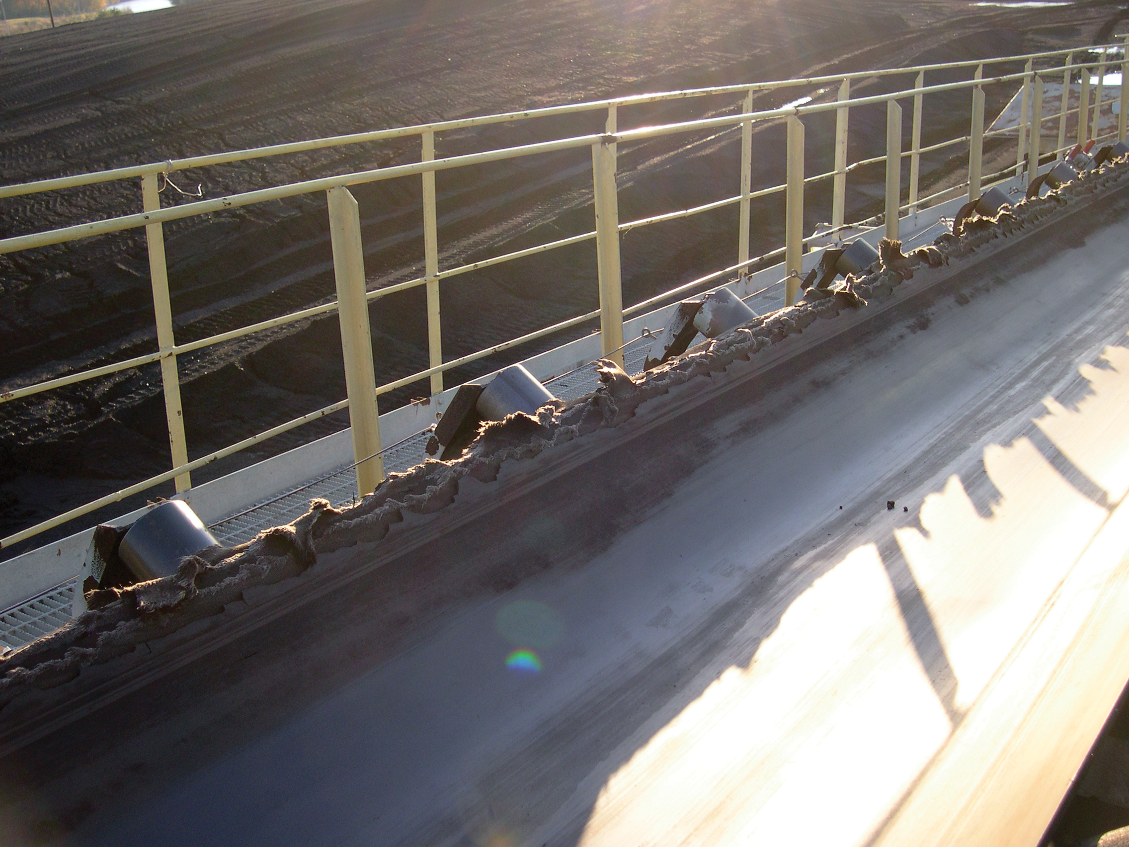 A conveyor belt is seen with very torn and rough edges.