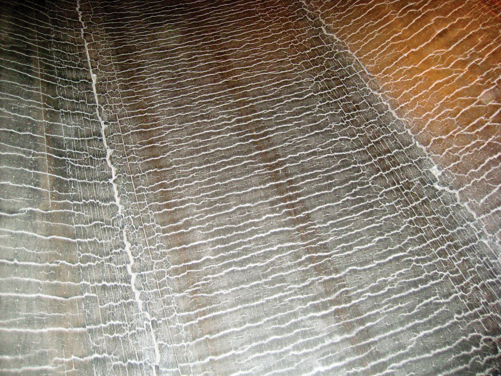 A close-up view of the top cover shows cracks throughout.