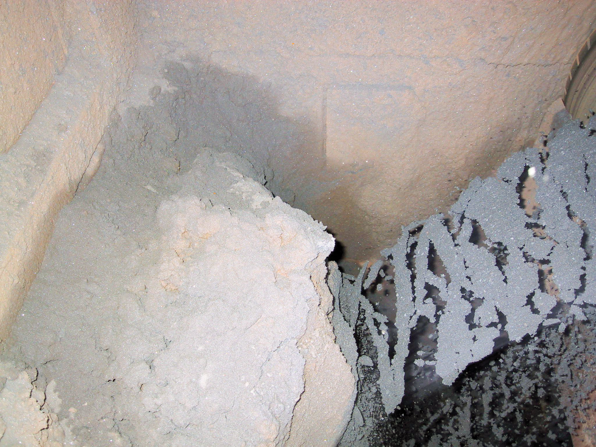 Material accumulated inside transfer chutes.