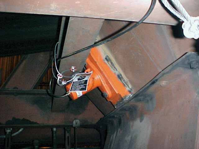Piston vibrator installed on a chute.