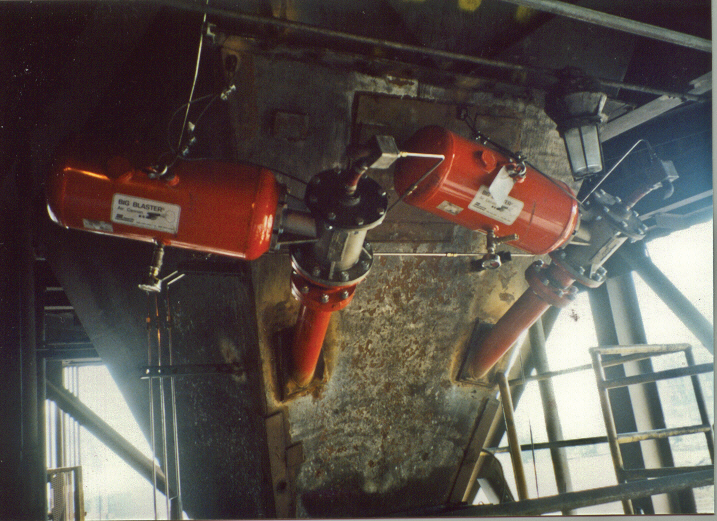 Two air cannons are mounted on a transfer chute.