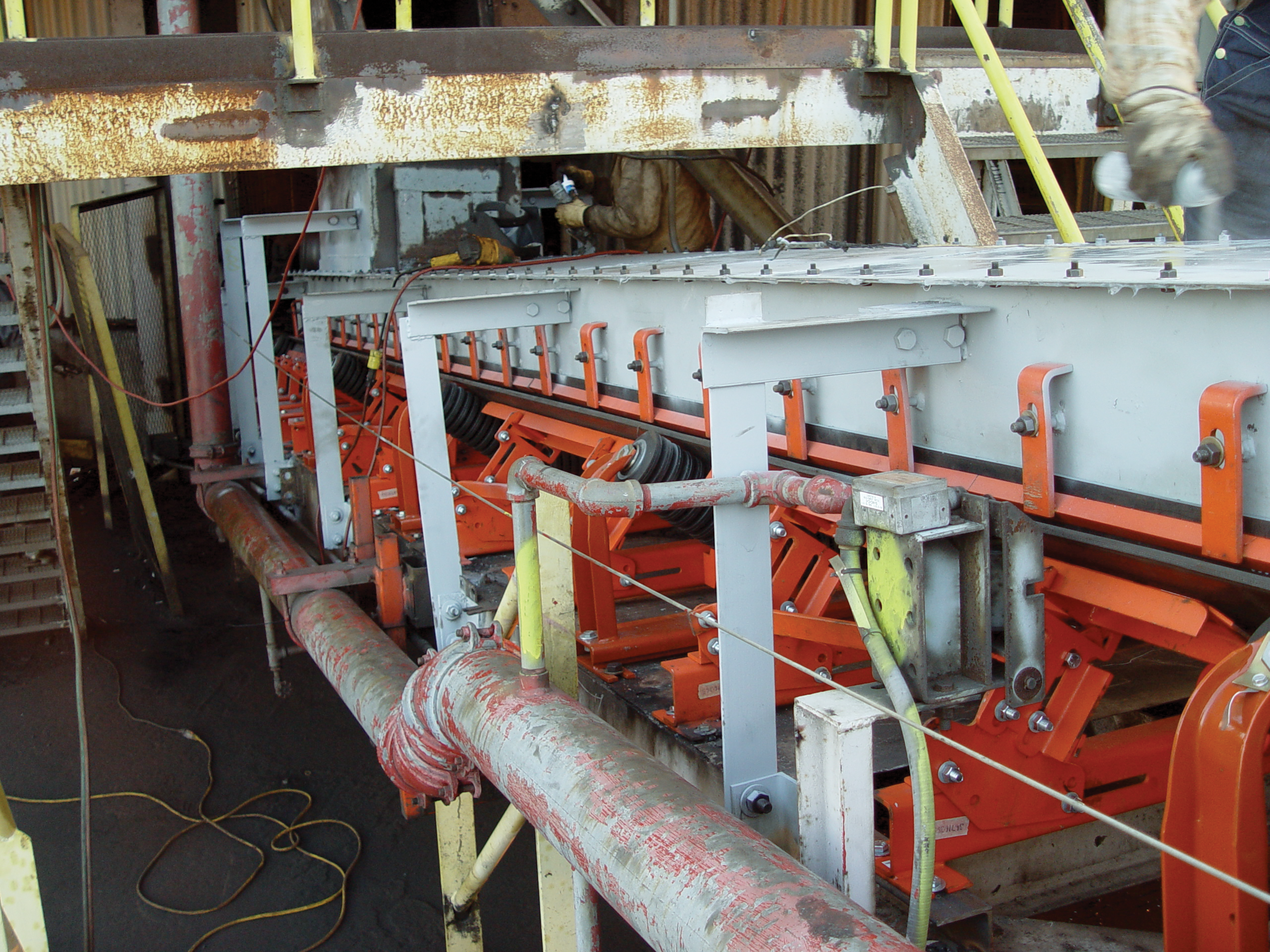 Belt support cradles and idlers installed in the load zone of a belt conveyor.