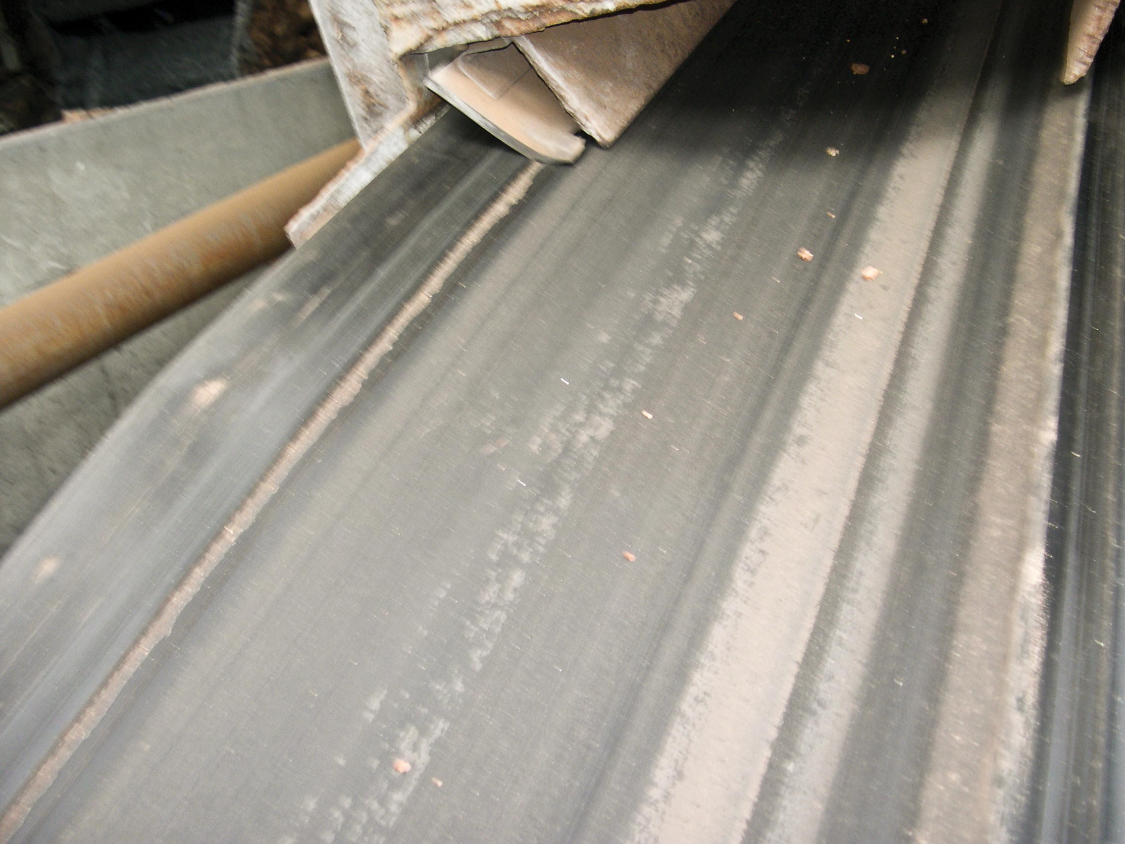 Conveyor belt with surface grooves due to entrapment damage.