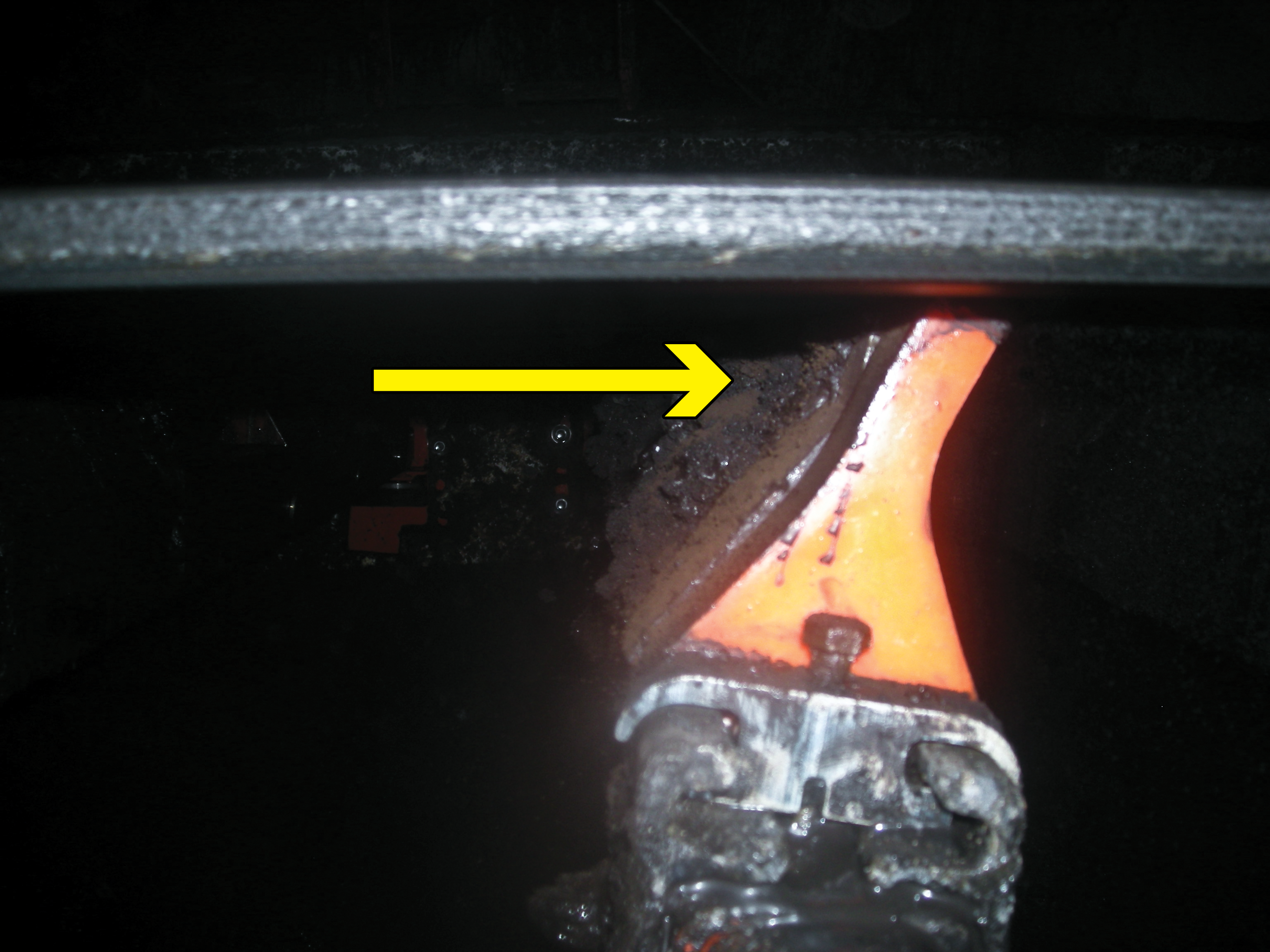Secondary belt cleaner at a scraping, or negative-rake, angle.