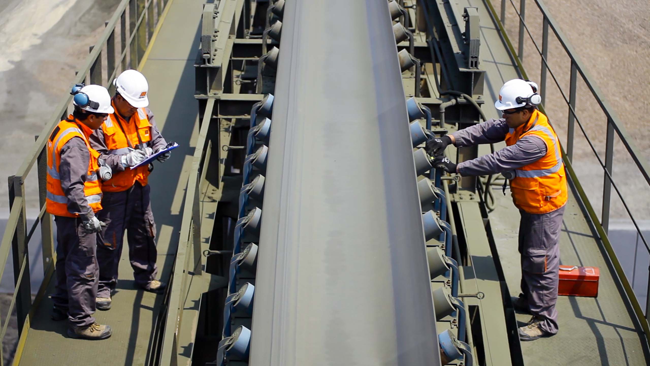 Workers perform a belt conveyor survey.